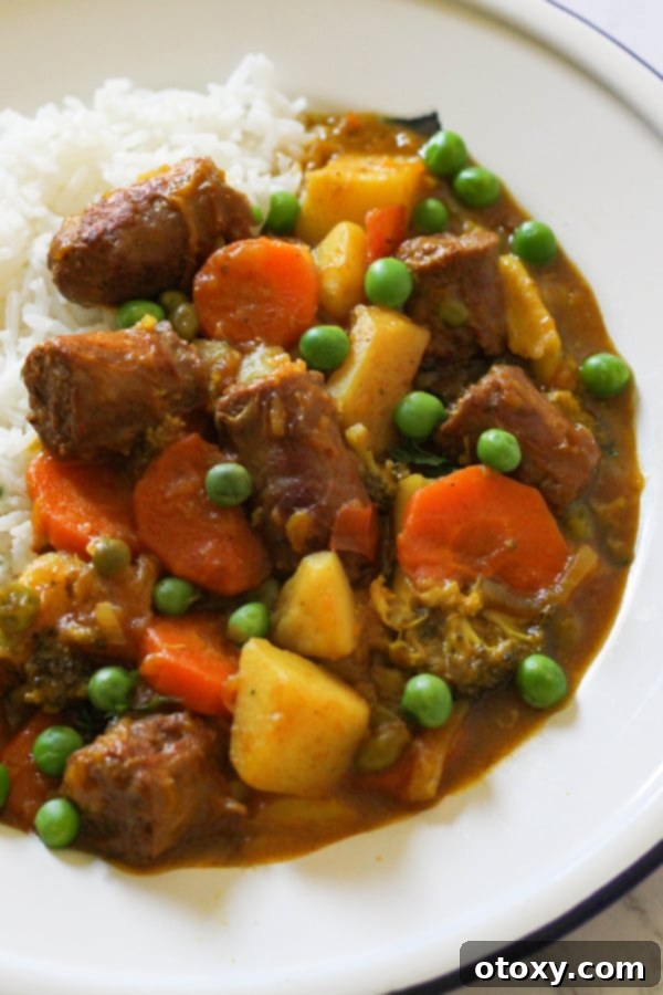 curried sausages on a bed of rice, perfectly plated for a comforting meal.