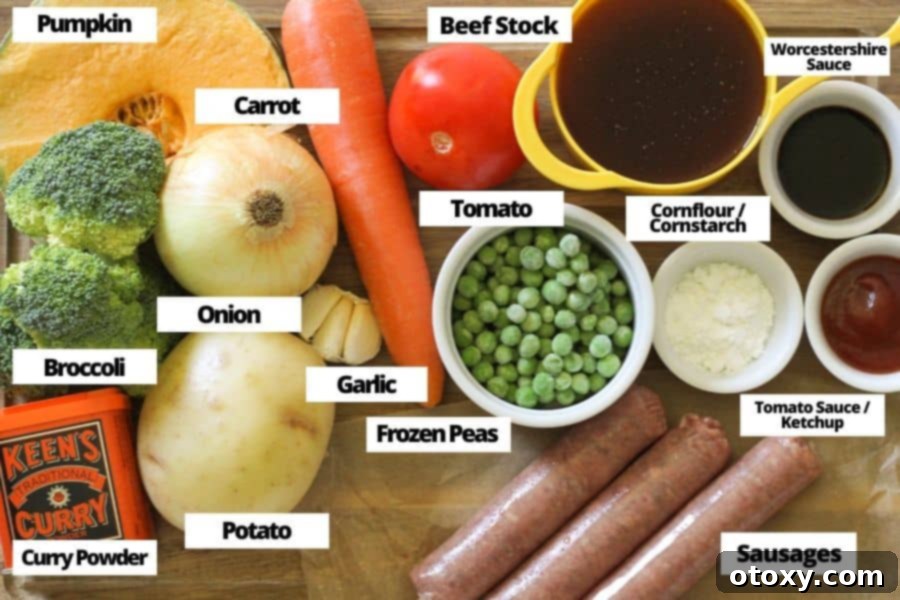 ingredients for curried sausages laid out on a rustic wooden cutting board, ready for preparation.