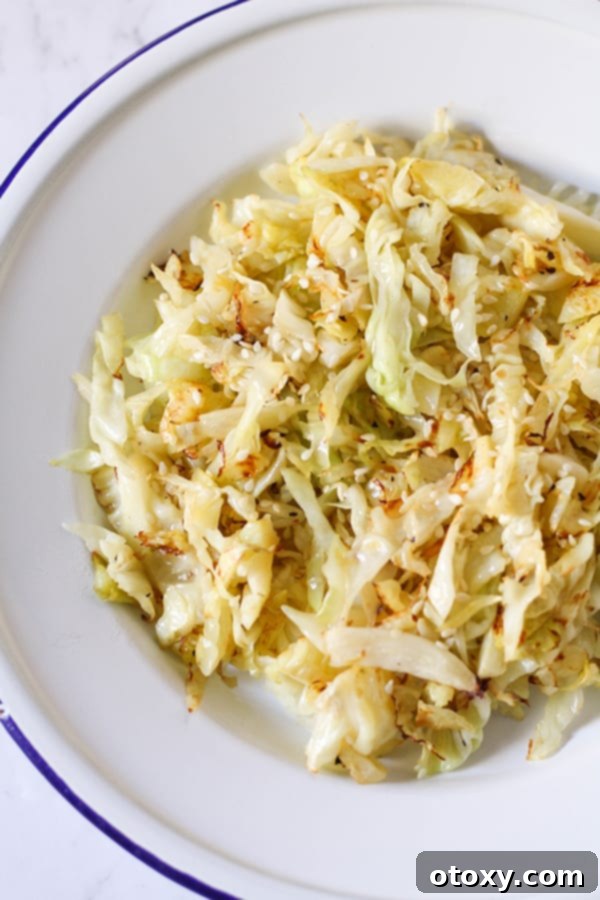 Crispy Pan-Fried Cabbage 2 Beautifully sautéed cabbage served in a white bowl, garnished lightly with fresh herbs.