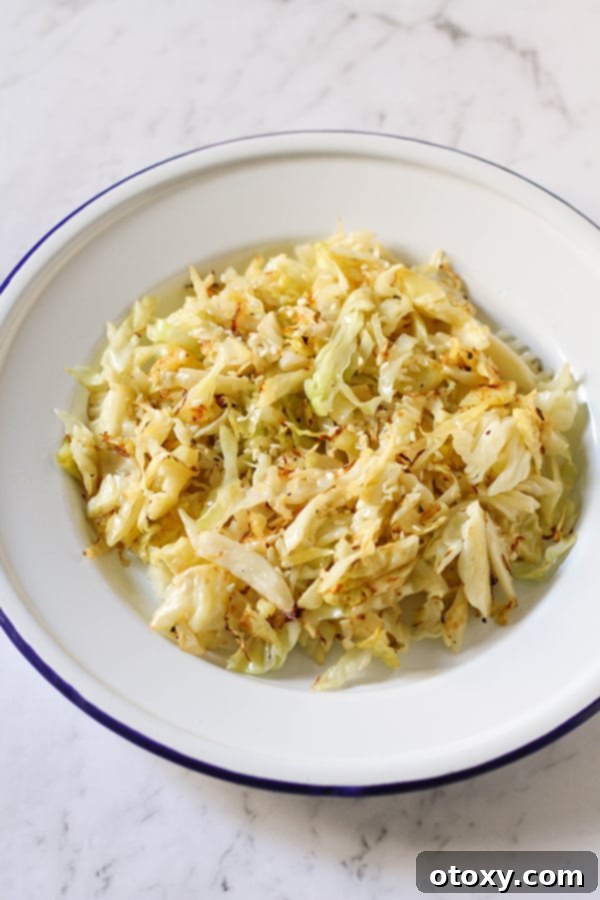 Crispy Pan-Fried Cabbage 5 A generous serving of perfectly sautéed cabbage in a clean white bowl, ready to be enjoyed.
