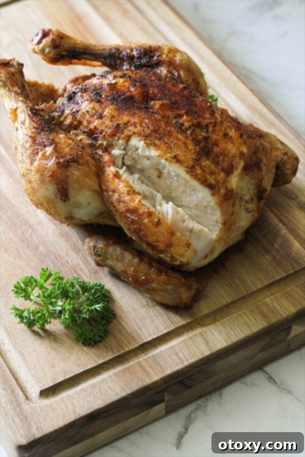 roast chicken on a wooden cutting board.