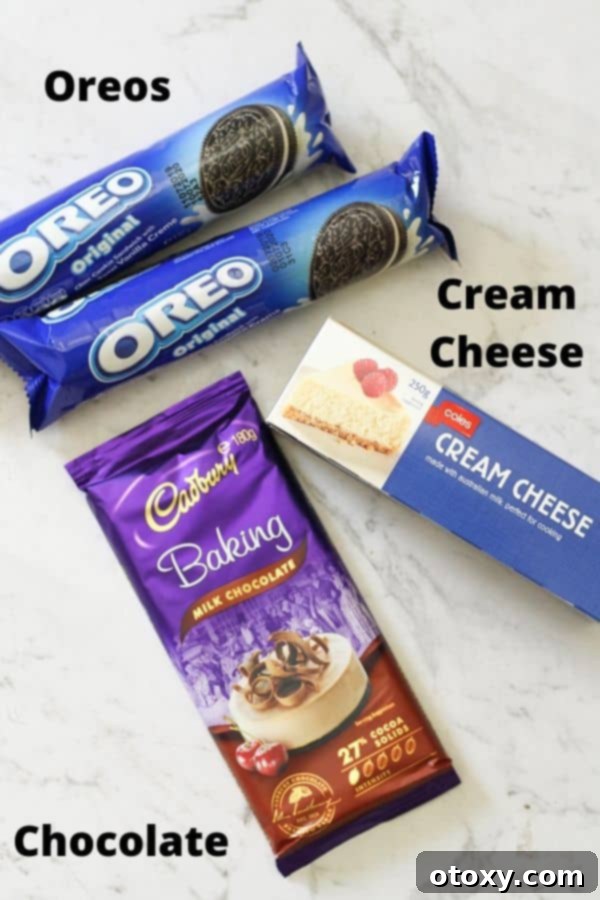 Creamy Oreo Cheesecake Truffles 4 ingredients for oreo balls laid on a white marble background.