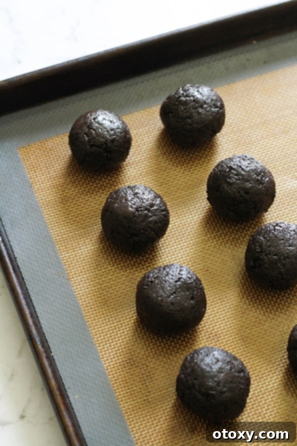 Creamy Oreo Cheesecake Truffles 7 oreo balls on a baking tray.