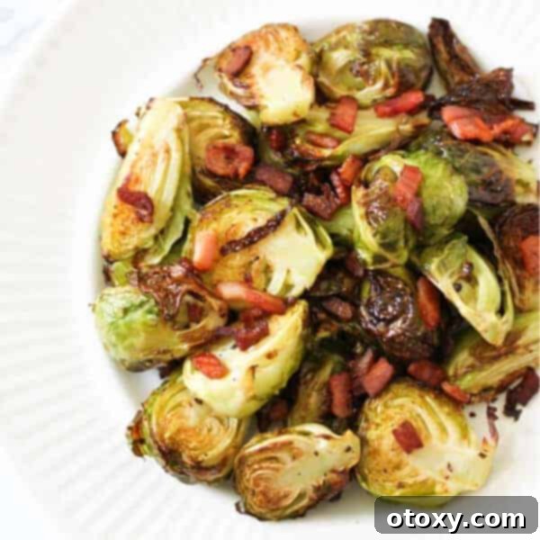 Crispy Brussels sprouts with bacon bits and a balsamic glaze, served in a rustic bowl.