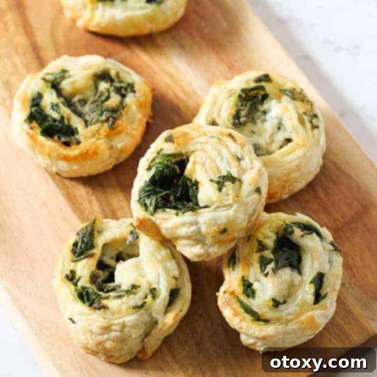 Golden brown spinach and feta pinwheels, baked to perfection with flaky puff pastry.