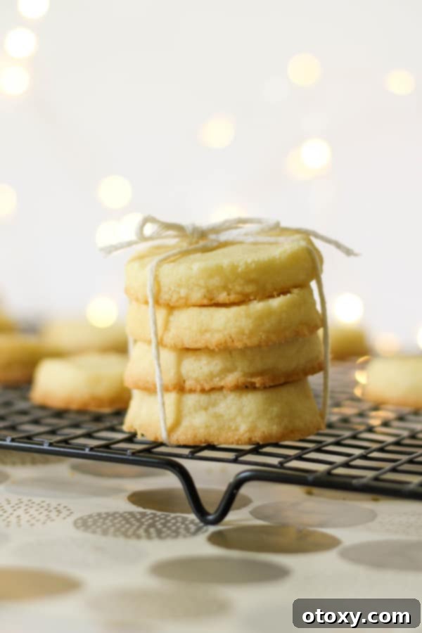 Stacked Christmas shortbread cookies on a wire rack, ready to be enjoyed or gifted.