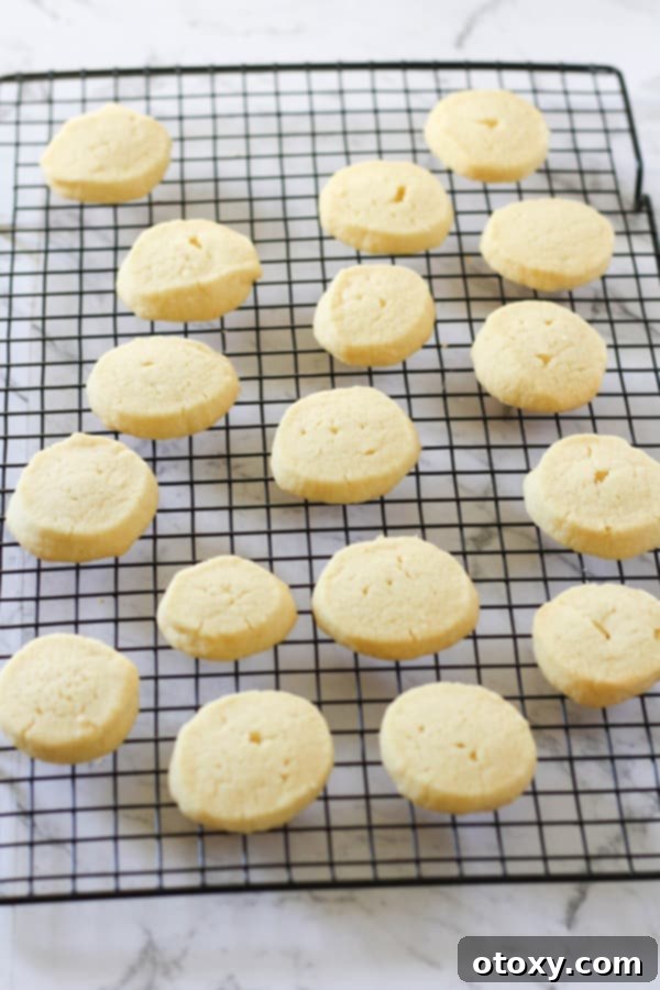 Freshly baked shortbread cookies cooling on a wire rack.