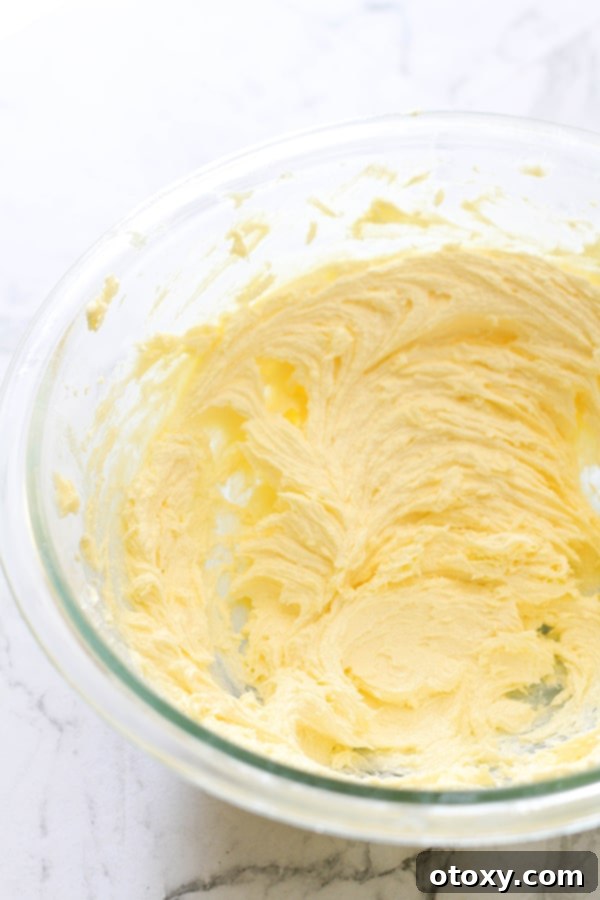 Whipped butter and caster sugar in a mixing bowl, showing the creamy texture.
