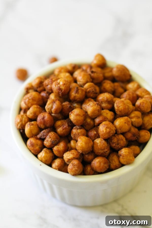 A final close-up shot of the crispy air-fried chickpeas served in a beautiful white bowl.