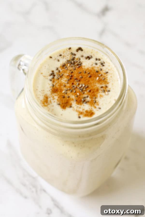 Creamy Chia Banana Blend 2 chia banana smoothie in glass jar with cinnamon and chia seeds sprinkled on top