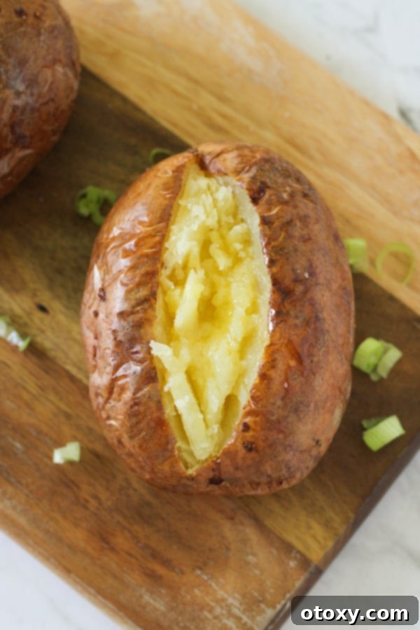 Air Fryer Potato Perfection 6 baked potato topped with butter.