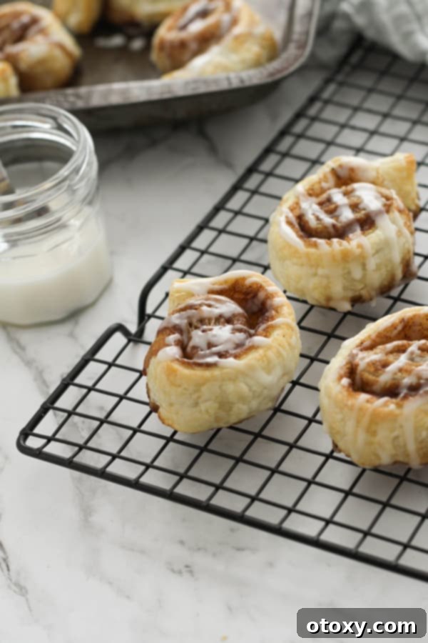 cinnamon rolls on a wire rack.