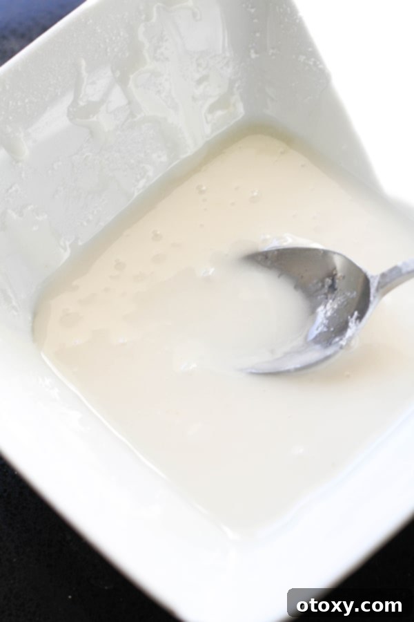 cinnamon roll glaze in a white bowl.