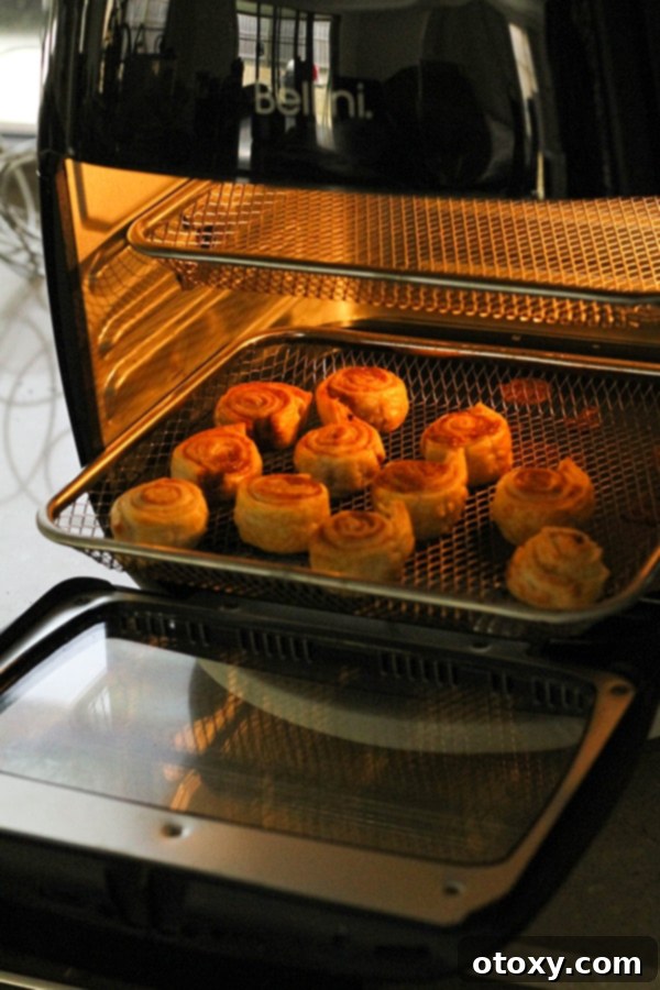 cinnamon pinwheels being cooked in the air fryer.