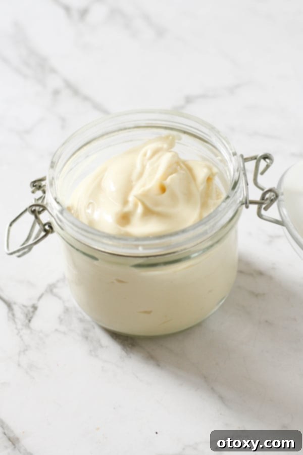 Homemade Whole30 Mayonnaise in a glass jar, perfect for healthy eating.