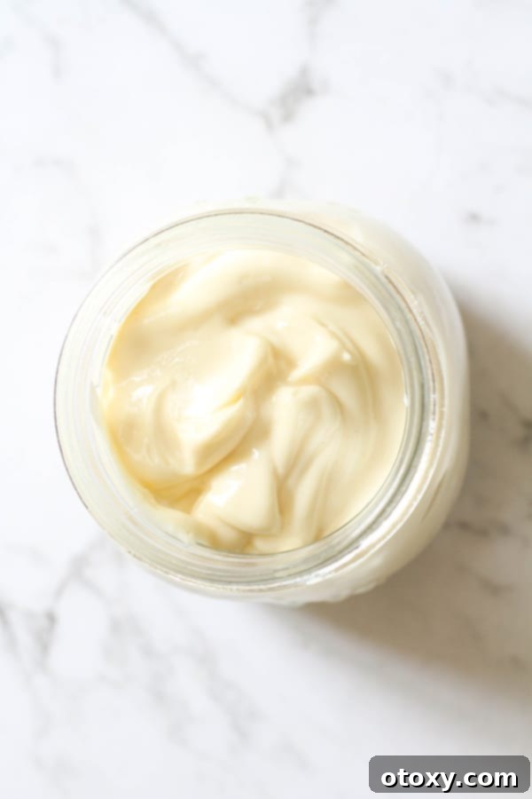 Creamy Whole30 Mayonnaise in a glass jar, ready to be used as a condiment.