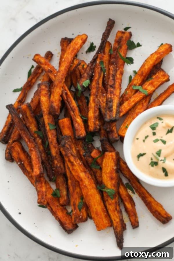 Crispy Air Fryer Carrot Fries served on a white plate, ready to be enjoyed.