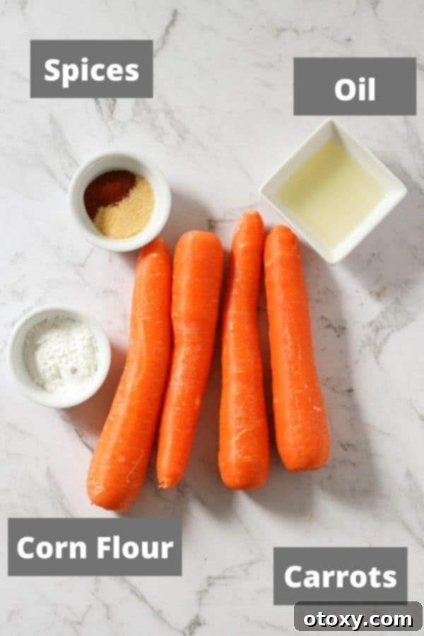 A flat lay image showing fresh carrots, olive oil, paprika, garlic powder, corn flour, and salt on a white marble background, ready for making air fryer carrot fries.
