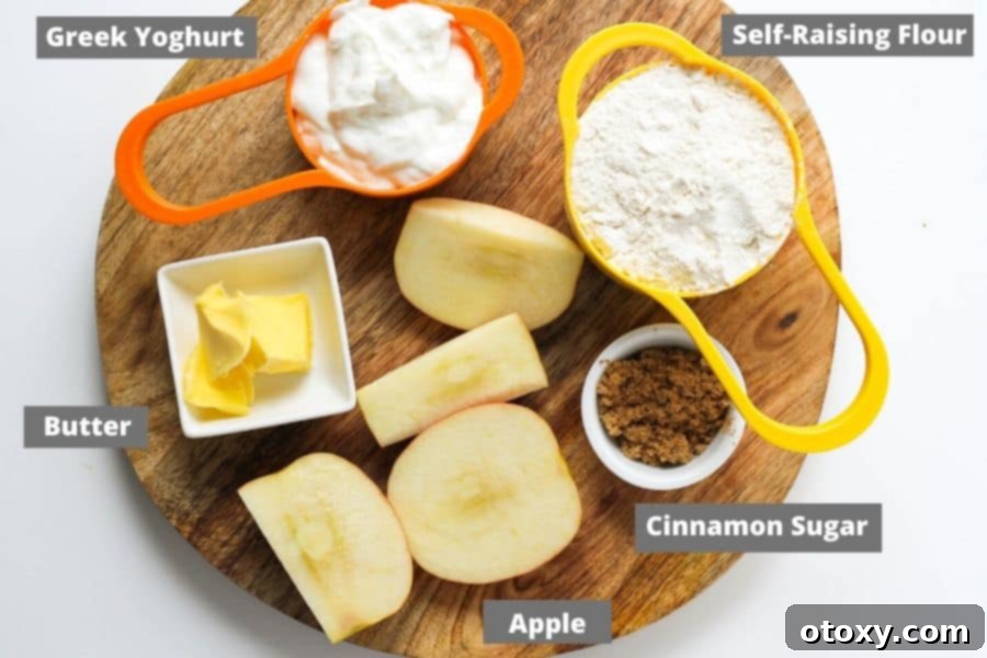 Air Fryer No Rise Apple Cinnamon Rolls 4 All the simple ingredients for Air Fryer Apple Cinnamon Rolls laid out on a wooden board: Greek yogurt, flour, butter, apple, brown sugar, and cinnamon.