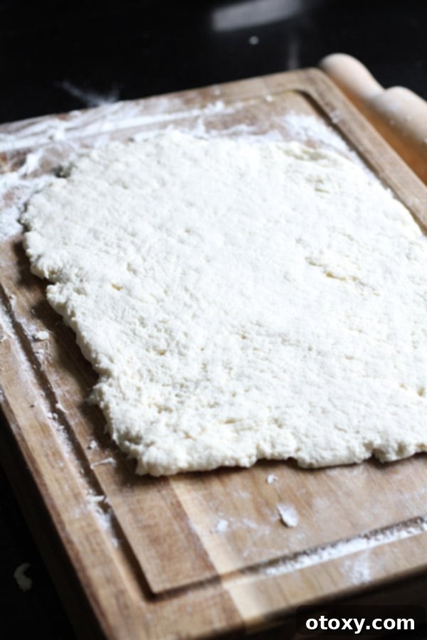 Air Fryer No Rise Apple Cinnamon Rolls 6 The two-ingredient dough, perfectly kneaded and shaped into a neat rectangle on a lightly floured wooden surface, ready for filling.