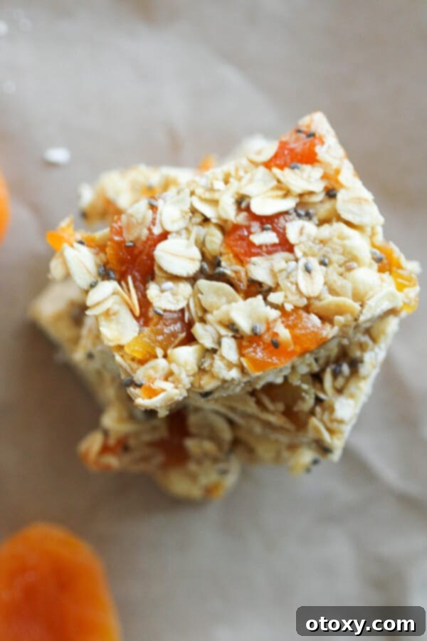 Effortless Chewy Apricot Granola Bars 5 chewy apricot muesli bars stacked on top of each other