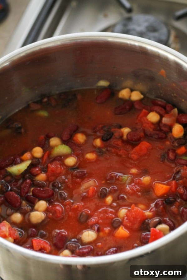 Triple Bean Vegetarian Chili 8 all vegetarian three bean chili ingredients in a large pot.