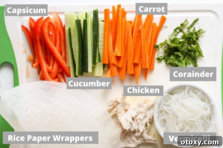 Fresh ingredients for chicken rice paper rolls, neatly displayed on a cutting board, ready for preparation.
