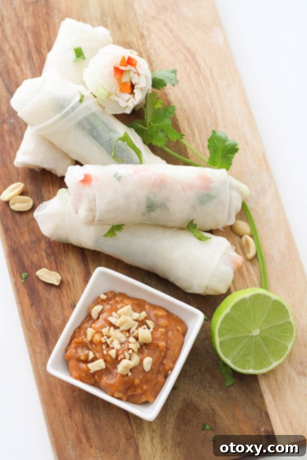 A final beautiful shot of chicken rice paper rolls, artfully presented on a wooden serving board, ready to be enjoyed.