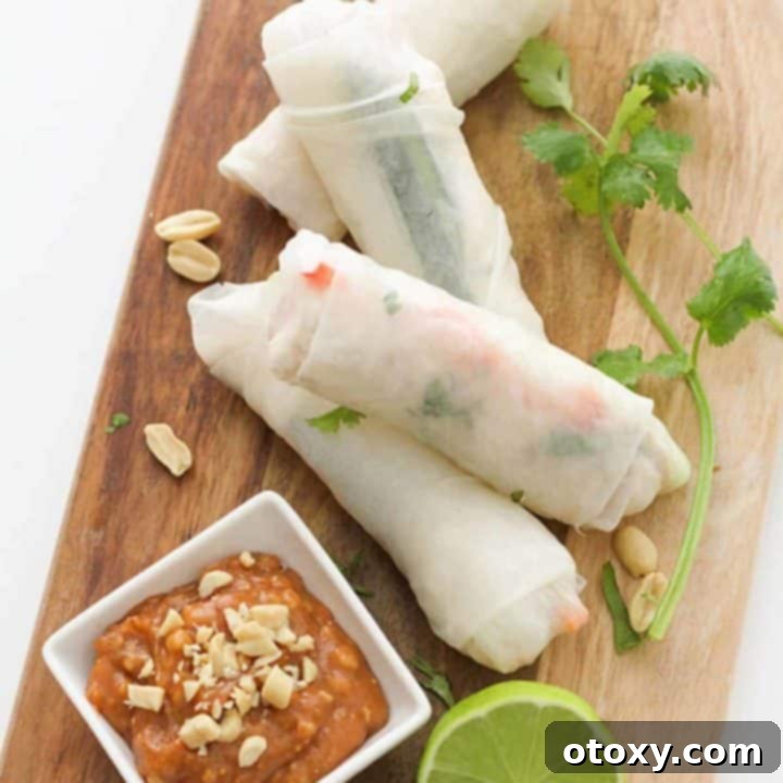 chicken rice paper rolls on a wooden serving board.