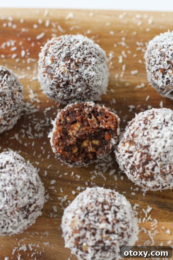 chocolate coconut energy balls on a wooden serving board, ready to be enjoyed as a healthy snack.