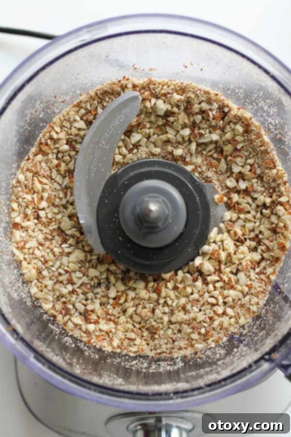 roughly chopped almonds in a food processor, ready for the next step.