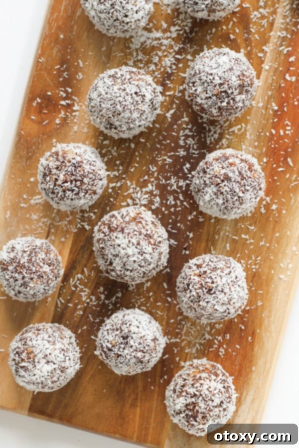 close-up view of chocolate coconut energy balls, showing the textured coating and rich interior.