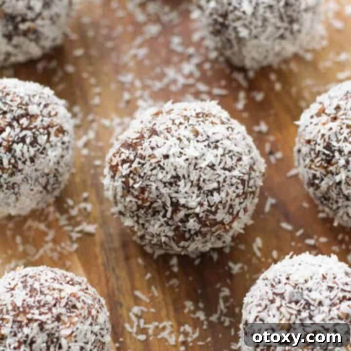 finished chocolate coconut energy balls arranged on a wooden board