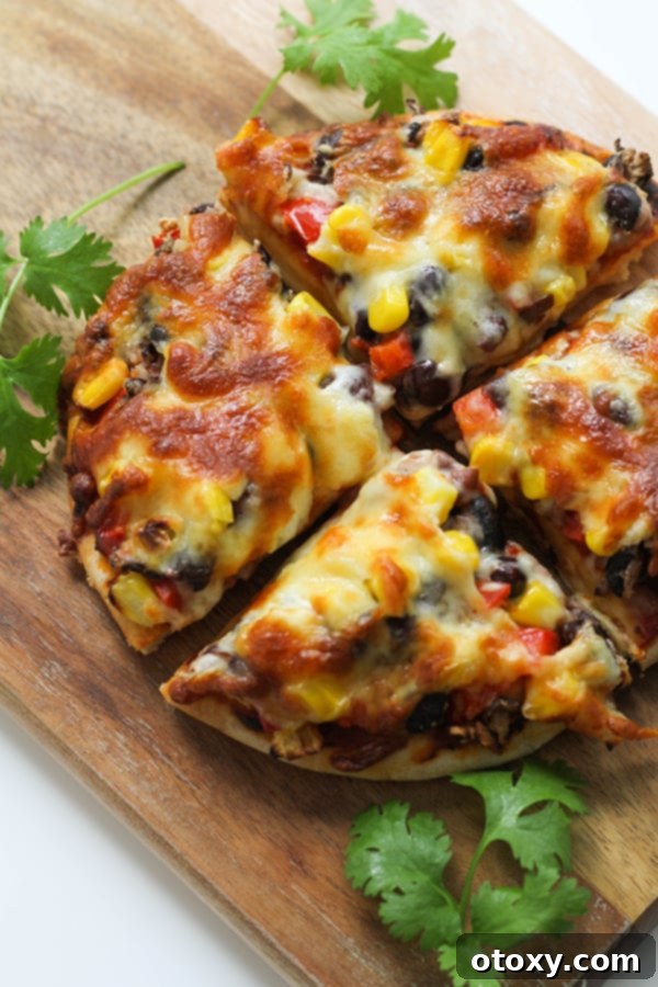 pizza cut into quarters on a wooden board.