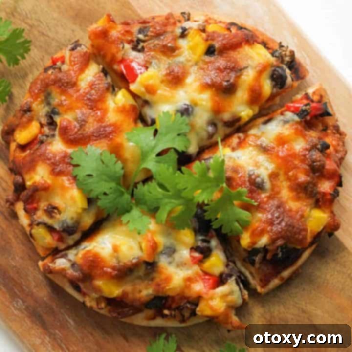 pizza cut into quarters on a wooden board.