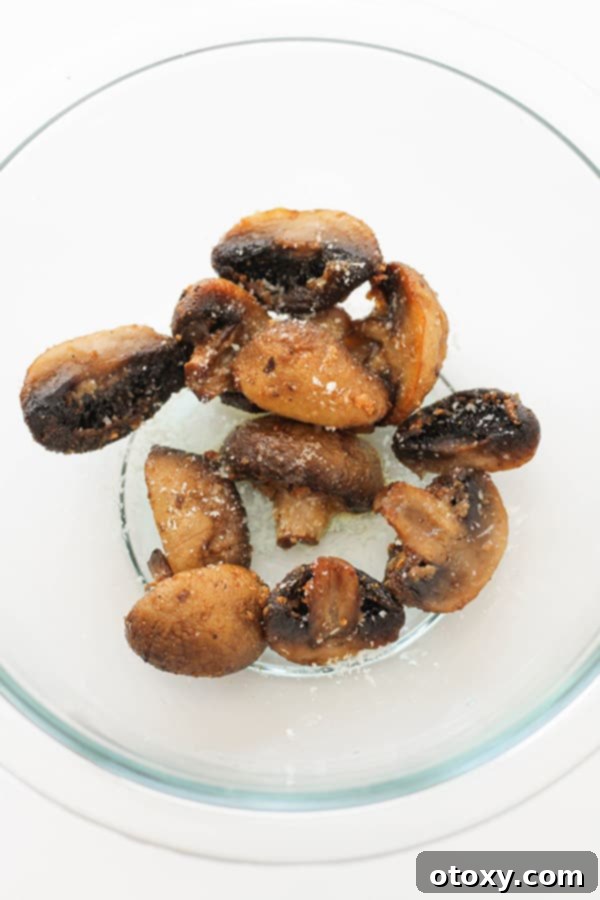 Crispy Air Fried Mushrooms 8 Cooked air fryer mushrooms in a glass bowl, ready for final seasoning.